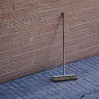 old wooden broom on the street photo