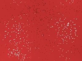 Confetti stars on a red paper Festive background photo