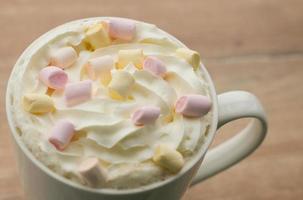 Coffee with whipped cream and marshmallows photo