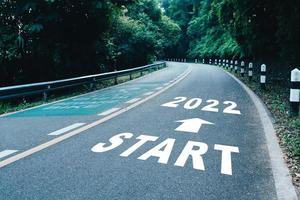 Start line to 2022 on road in wood the beginning of a journey to the destination in business planning strategy and challenge or career path opportunity photo