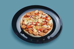 Sausage and Crab Stick Pizza in ceramic plate photo