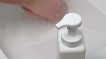 A man washes his hands with soap in the bathroom video