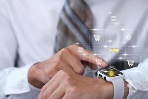 Businessman using smartwatch and virtual screen and internet data and technology in the future concept photo