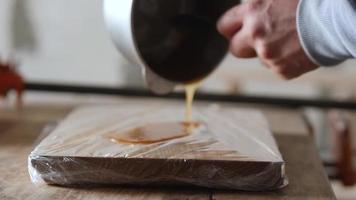 pouring liquid carpentry glue from a bowl video