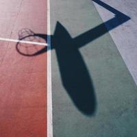 hoop shadows on the street basketball court photo