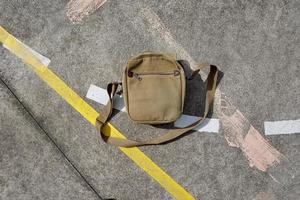 brown bag and accesories on the ground photo