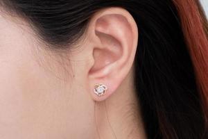 Diamond earring on the ear of an Asian woman photo