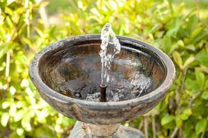 Old metal water fountain in the park photo