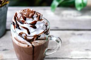 Hot chocolate cocoa in glass mug with whipped cream photo