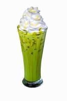 Iced matcha green tea with whipped cream in tall glass isolated on white background photo