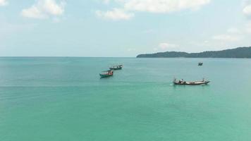 Fisherman boats off Koh Rong Samloem. Tropical sea waters on sunny day. Aerial view video