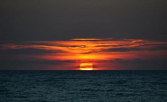 hermosa puesta de sol naranja en el cuerpo de agua foto