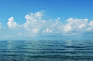 Body of water under white clouds photo