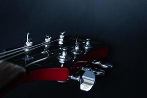 Red electric guitar closeup  on black background photo