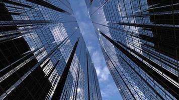 business towers camera animation among high rise buildings with blue reflective sky video