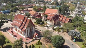 Fly-over survey view of Chalong Temple grounds and shrines in Phuket, Thailand - Aerial Fly-over low angle panoramic shot video