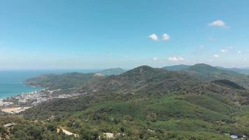 Southern Phuket lush jungle and Mountainous Landscape surrounded by Andaman Sea in Thailand - Aerial Low Panoramic shot