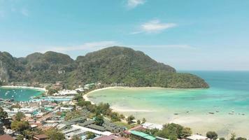 Divine Loh Dalum Beach awash with warm Andaman sea waters in Ko Phi Phi Don Island, Thailand - Aerial Fly-over shot video