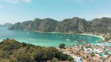 Reveal of Ton Sai Beach encircled by enchanting Ko Phi Phi Don Island Landscape, Thailand - Aerial Fly-over Reveal shot