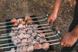 Man frying shish kebab on the grill photo