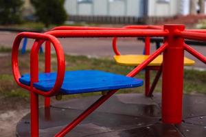 Empty red children's swing photo