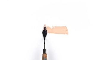A painting palette knife isolated on a white background with pink photo