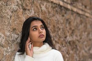 Close up portrait of a romantic brunette girl looking upwards photo