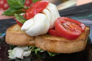 Tomato mozzarella and basil bruschetta photo