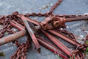 Old tractors and other farm material on a scrap yard photo