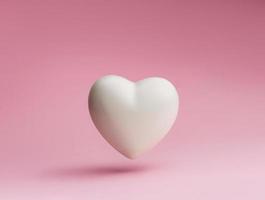 símbolo del corazón blanco sobre un fondo rosa pastel foto