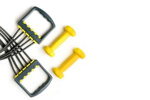two dumbbells and an expander on a white background photo