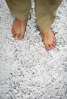 Bare feet on snowy grass photo