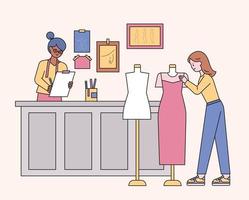 Boutique shop designers and customers looking at clothes. flat design style minimal vector illustration.