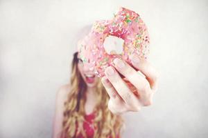 Funny young woman with a donut photo