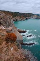 Acantilado de rocas y mar en la costa de Bilbao, España foto