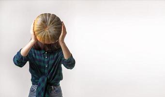 Facelaess woman is holding pumpkin Concept photo with copy space