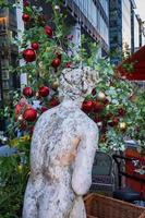 A statue and a tree in Christmas decoration in Spinningfields modern development area in  Manchester England photo