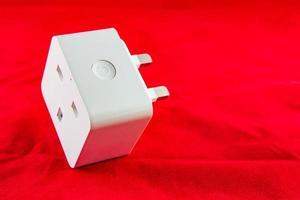 WiFi Smart Power Socket of White color on a red background photo