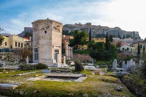 Tower of the Wind gods in Roman Agora and Acropolis in the background photo