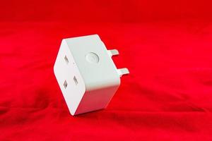 WiFi Smart Power Socket of White color on a red background photo