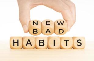From Bad to new habits concept Hand turns a wooden blocks with bad to new words photo