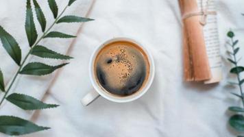 Top view of cup of coffee on a white tablecloth photo