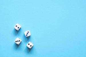 White bone dice on blue background photo
