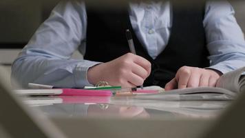 Teenage girl in a school uniform does homework video
