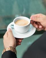 Man drinking latte coffee close up photo