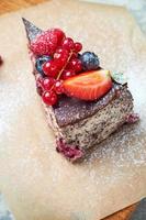 Cherry berry cake decorated with berries on a wooden board photo