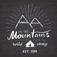 Mountains handdrawn sketch emblem. outdoor camping and hiking activity, Extreme sports, outdoor adventure symbol, vector illustration on chalkboard background