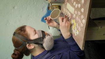 Female ceramist paints a clay product Vertical video