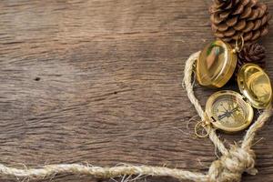 Old Compass and rope on wood background photo