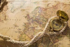 old compass and rope on vintage map photo